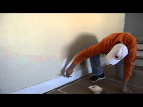 Painting the baseboards on your rental to make them look new